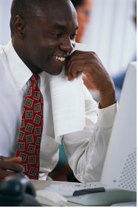 man smiling at computer